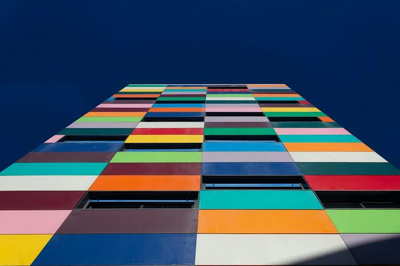Colourful facade of a high-rise building seen from below
